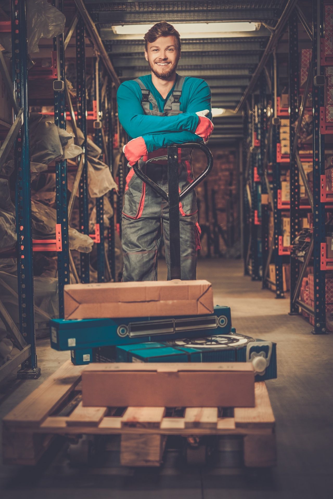 Loader using hand pallet truck in a warehouse